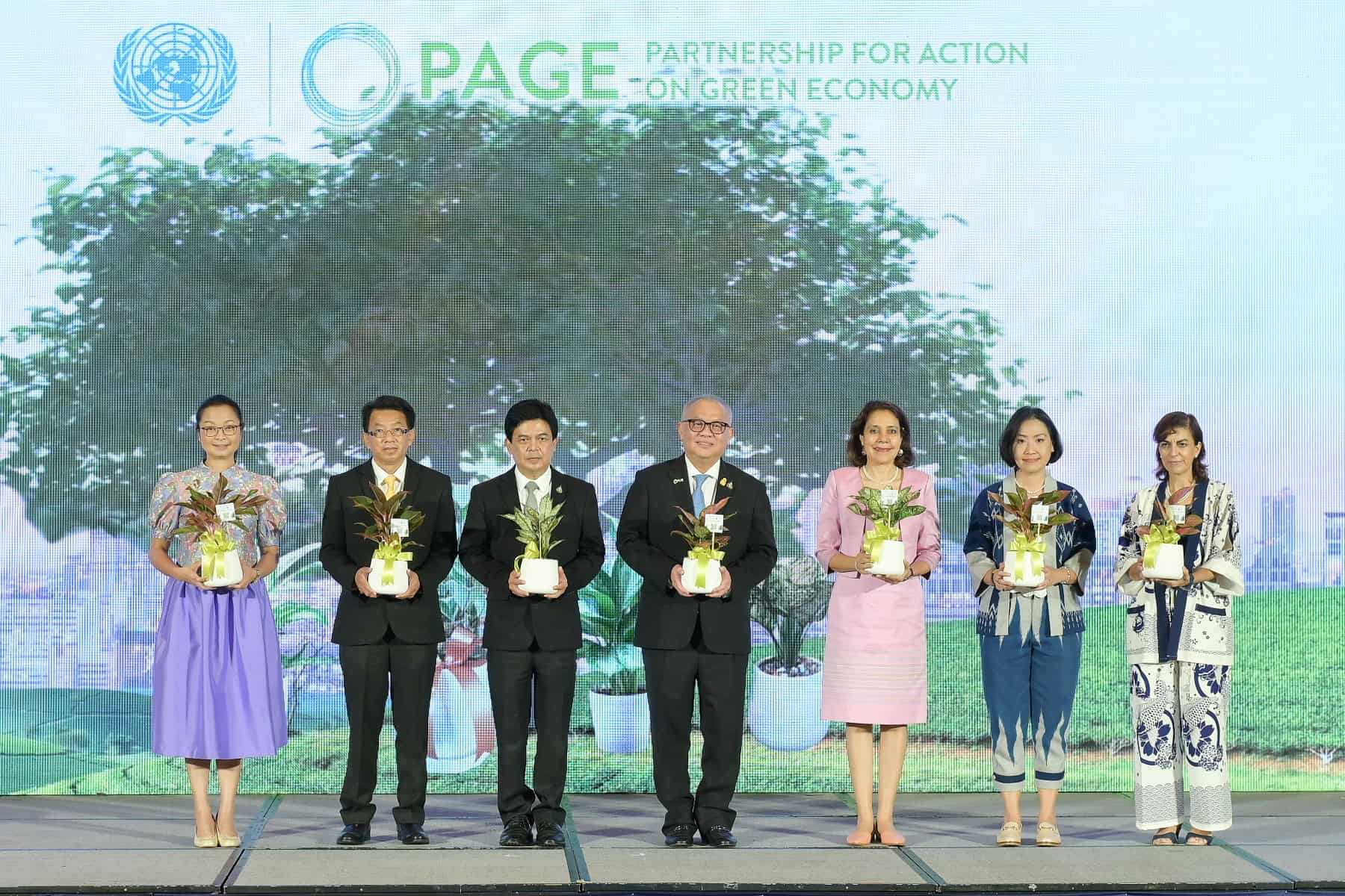 A group of people standing on a stage at the PAGE launch event in Thailand in 2022.