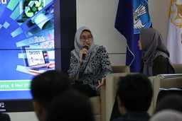 A woman speaking with a mic at a PAGE workshop in Indonesia