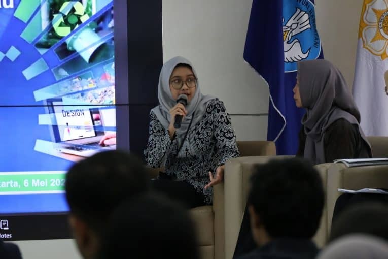 A woman speaking with a mic at a PAGE workshop in Indonesia