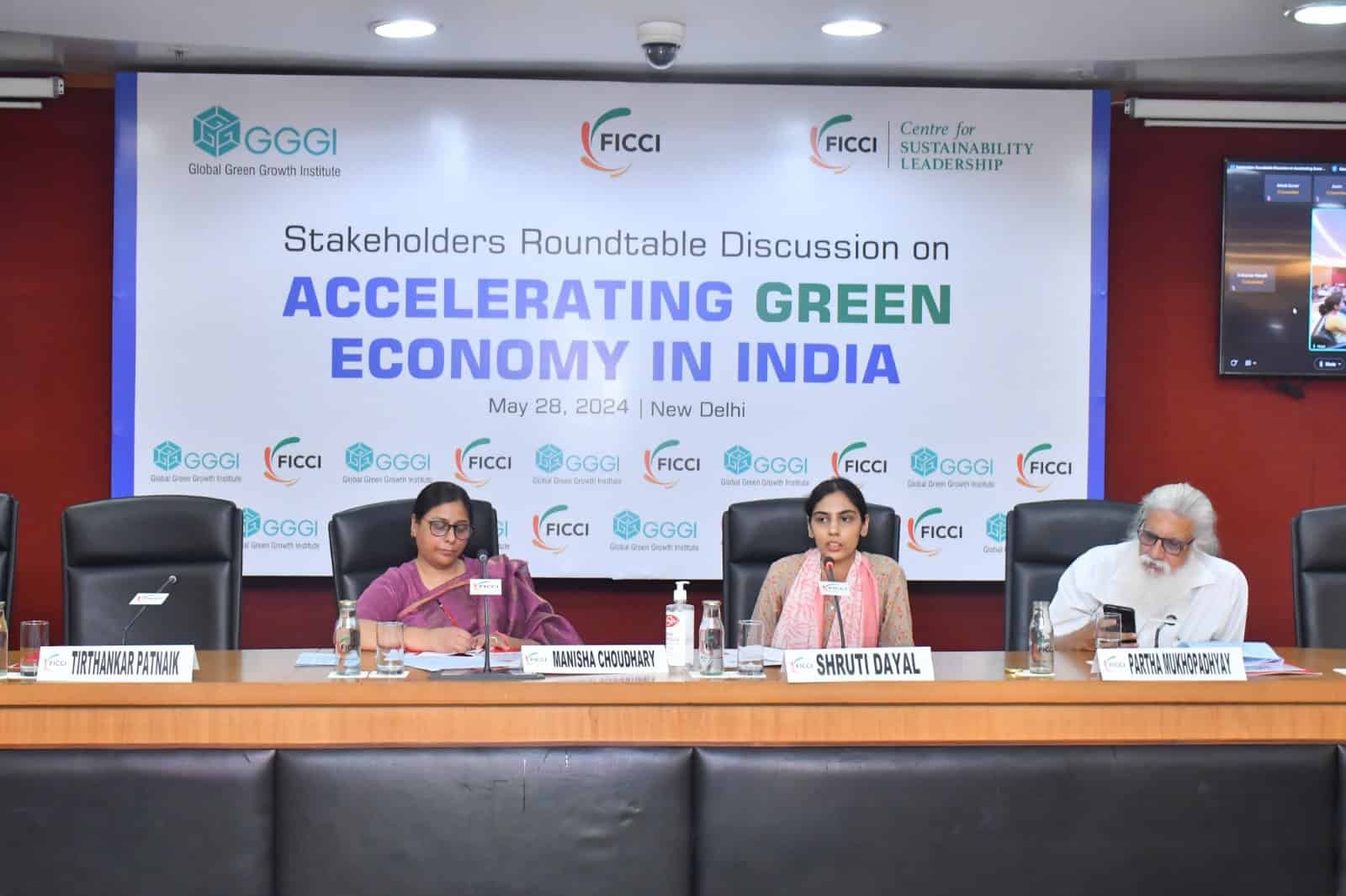 A group of people sitting at a table for a panel discussion on Accelerating Green Economy in India