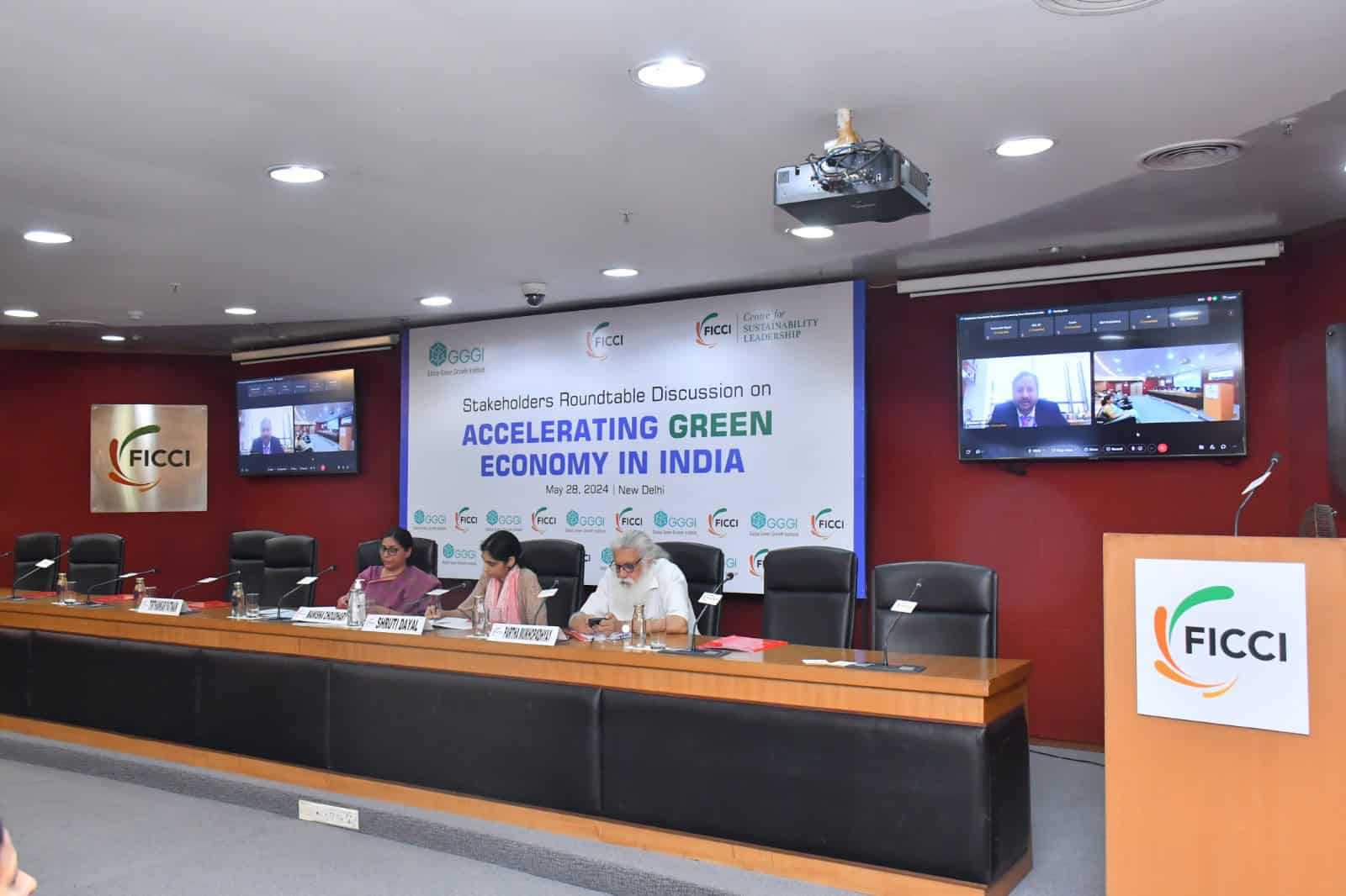 People at a table taking part in the discussion on Accelerating green economy in India